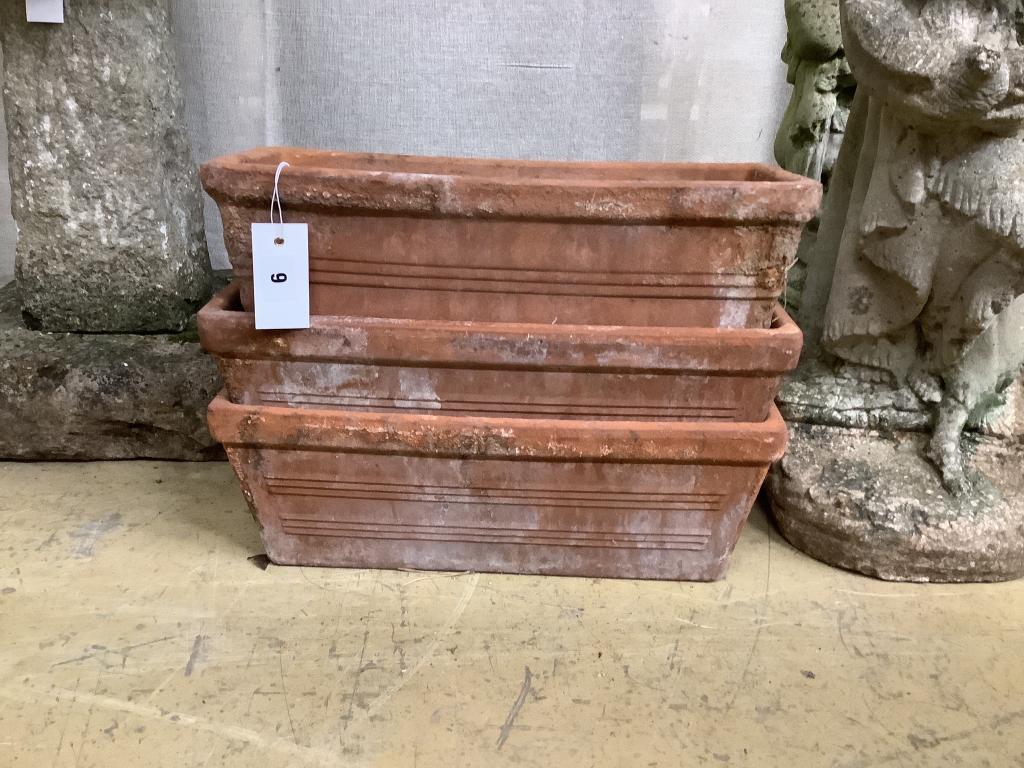A set of three terracotta garden troughs and four similar troughs, approx. 40cm, wide